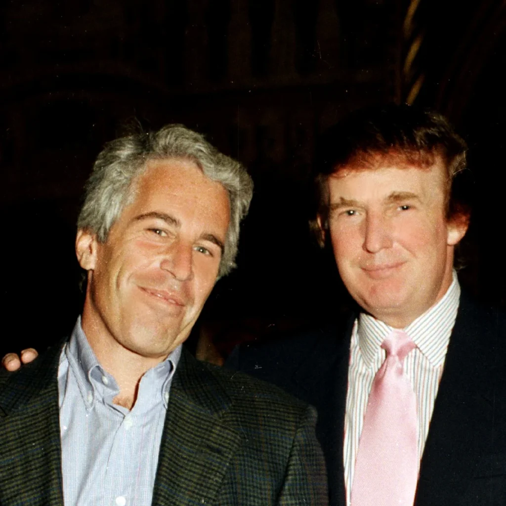 Jeffrey Epstein (left) and Donald Trump (right) posing together at a social event in the 1990s. Both are smiling, dressed in formal attire.